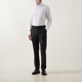 Model wearing Paul Smith white slim fit single cuff cotton shirt, styled with dark charcoal trousers and black leather shoes.