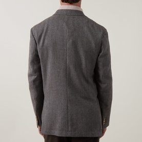 Model wearing Paul Smith charcoal wool-cashmere jacket, rear view showing tailored back seam and notched collar