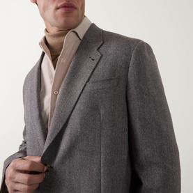 Model wearing Paul Smith charcoal wool-cashmere jacket with notch lapel and chest pocket, styled with a light pink shirt.