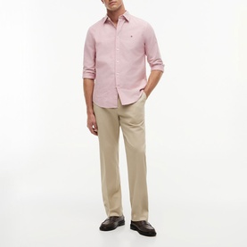 Model wearing Tommy Hilfiger medium red long-sleeve shirt, styled with beige chinos and dark brown loafers