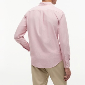 Model wearing Tommy Hilfiger medium red long-sleeve shirt, back view, styled with beige chinos.