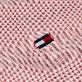 Tommy Hilfiger medium red Oxford fabric close-up with embroidered flag logo badge detail