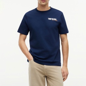 Model wearing Tommy Hilfiger Carbon Navy crew-neck T-shirt with chest logo, styled with stone chinos.