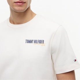 Model wearing Tommy Hilfiger Ivory Petal crew neck T-shirt with navy and orange branded chest logo graphic