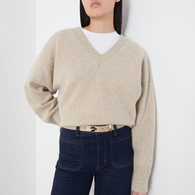 Model with Victoria Beckham Dorian Pin Buckle Belt in Safari, gold-tone hardware, worn over dark jeans with a beige knit sweater.