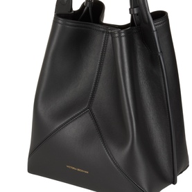 Victoria Beckham black leather bucket bag with angular panelling, top handles, and gold-tone branding detail