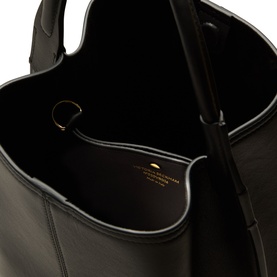 Victoria Beckham black leather bucket bag, interior view showing suede lining and gold-tone hardware detail