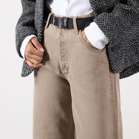 Model wearing AgoldE Wide Leg jeans in Trail, styled with a black leather belt, white shirt and grey textured blazer.
