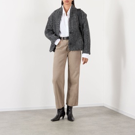 Model wearing AgoldE Trail wide leg jeans in taupe, styled with a grey knit cardigan, white shirt and black ankle boots.