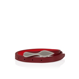 Christian Louboutin red leather ladies belt with silver-tone buckle, shown coiled, revealing iconic red lining.