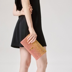 Model carrying Christian Louboutin clutch bag in multi ombre crystal embellishment with gold-tone clasp, styled with black mini dress