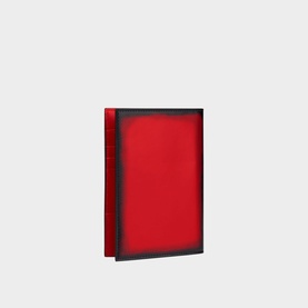 Christian Louboutin red leather bifold wallet with dark navy edge trim, compact rectangular silhouette