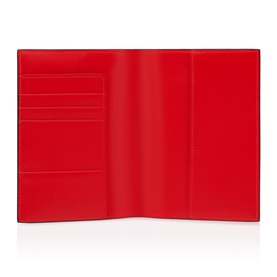 Christian Louboutin red leather passport holder, open flat showing card slots and document compartments with clean interior lining