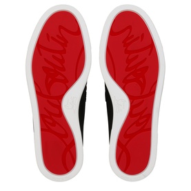 Christian Louboutin black women's sneaker soles showing signature red lacquered outsoles with white rubber edges and script logo detailing.