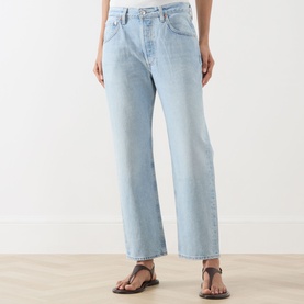 Model wearing Citizens of Humanity Winslow Boyfriend Jeans in Horizon light wash, straight leg, with brown leather strap sandals.