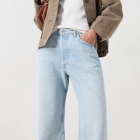 Model wearing Citizens of Humanity Winslow Boyfriend Jeans in Horizon light wash, styled with a white tee and khaki blazer