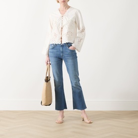 Model wearing Citizens of Humanity Goldie Ankle Kick Flare Jeans in Calla, mid-blue with raw hems, styled with white broderie top and tan tote bag.