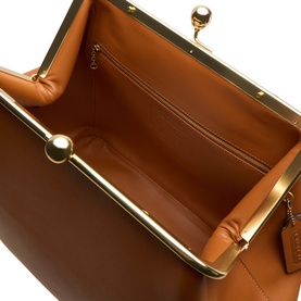 Coach Kisslock Large Frame Bag in Amber Brown leather, open interior view showing zip pocket and gold-tone kisslock frame hardware