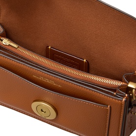 Coach Tabby 20 Shoulder Bag in amber pebbled leather, open interior view showing fabric lining, zip pocket and gold-tone hardware detail