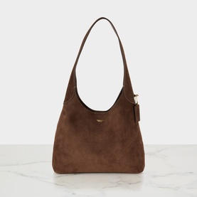 Coach shoulder bag in dark chocolate suede with gold-tone hardware and single top handle, structured hobo silhouette