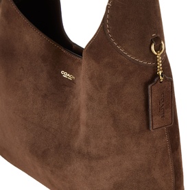Coach dark chocolate suede shoulder bag, gold-tone hardware and logo charm tag, contrast stitching detail, close-up view