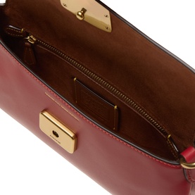 Coach poppy red leather shoulder bag interior view, showing gold-tone zip pocket, card slot, and gold push-lock closure detail