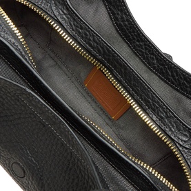 Coach black leather shoulder bag interior view, showing gold-tone zip, fabric lining, and tan leather label