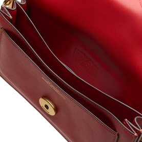 Coach poppy red leather shoulder bag open interior view, gold-tone turn-lock closure, red suede lining with embossed logo