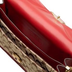 Coach Poppy Signature shoulder bag interior, red leather lining with gold hardware clasp and jacquard fabric body visible