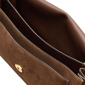 Open interior view of dark brown suede shoulder bag with gold-tone press-stud closure and embossed logo lining