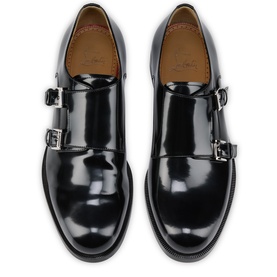 Christian Louboutin black patent leather double monk strap shoes with silver buckles, tan leather lining, and black sole, overhead view