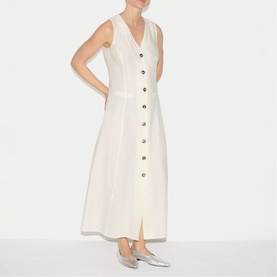 Model wearing Jigsaw cream sleeveless maxi dress with V-neck, button-through front, styled with silver flat mules.