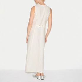 Model wearing Jigsaw cream sleeveless maxi dress, back view, with gold belt detail, styled with silver flat shoes.