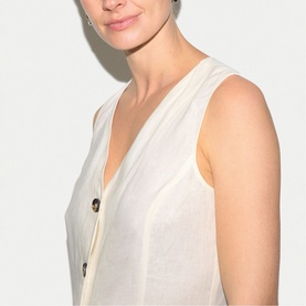 Model wearing Jigsaw cream sleeveless V-neck dress with button detail, close-up shot showing neckline and bodice.