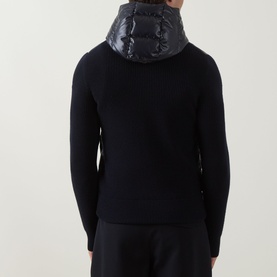 Model wearing Moncler navy wool cardigan with quilted glossy hood detail, rear view