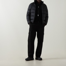 Model wearing Moncler black virgin wool cardigan with black puffer jacket, cargo trousers and chunky black shoes.