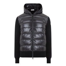 Moncler black cardigan with quilted down-filled front panel, hood, zip fastening, and knit sleeves and hem