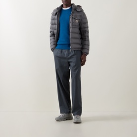 Model wearing Moncler Navy Cotton Crew Neck, styled with grey quilted hooded jacket and charcoal straight-leg trousers.