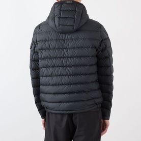 Model wearing Moncler Galion Short Down Jacket in black, rear view, showing quilted finish, hood, and sleeve logo badge pocket.