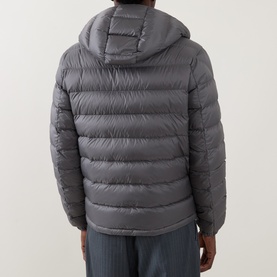 Model wearing Moncler grey hooded puffer jacket, rear view, shown with grey trousers