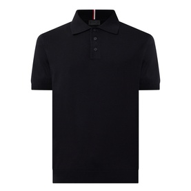 Moncler black cotton polo shirt with three-button placket, short sleeves, and signature red and white collar stripe detail.