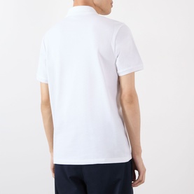 Model wearing Moncler white cotton polo shirt, rear view, styled with navy trousers