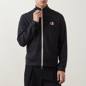 Model wearing Moncler dark blue zip-up sweatshirt with stand collar, contrast zip, and embroidered logo patch on chest