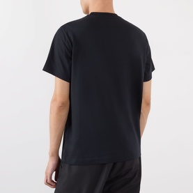 Model wearing Moncler Felt Logo Graphic T-Shirt in navy. Crew neck, short sleeves, straight hem shown from the back.