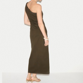 Model wearing Jigsaw khaki one-shoulder maxi dress with ruched detail, styled with gold strappy sandals and white bangles.