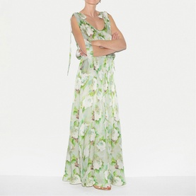 Model wearing Jigsaw green floral maxi dress with V-neckline, sleeveless design and tie shoulder detail, full-length silhouette.