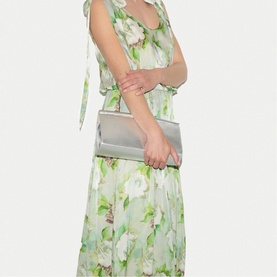Model wearing Jigsaw green floral maxi dress with tie shoulders, styled with a silver clutch bag