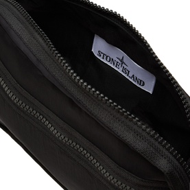 Stone Island black polyurethane pouch bag, open to show white branded interior label and zip closure detail