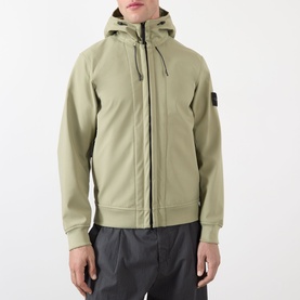 Model wearing Stone Island Softshell-R_e.dye&reg; Wind Resistant Jacket in laurel green with hood up, two-way zip, raglan sleeves and sleeve badge detail