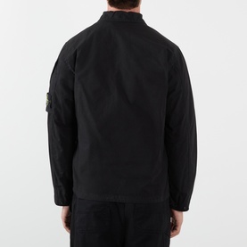 Model wearing Stone Island black cotton casual shirt, rear view, with signature compass badge on left sleeve